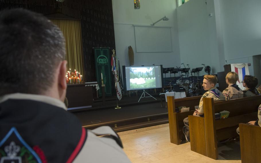 Leaders and Scouts with Wiesbaden's Boy Scout Troop 107 watch a video marking the 60th anniversary of their troop during a meeting in Wiesbaden, Monday, Sept. 18, 2017.