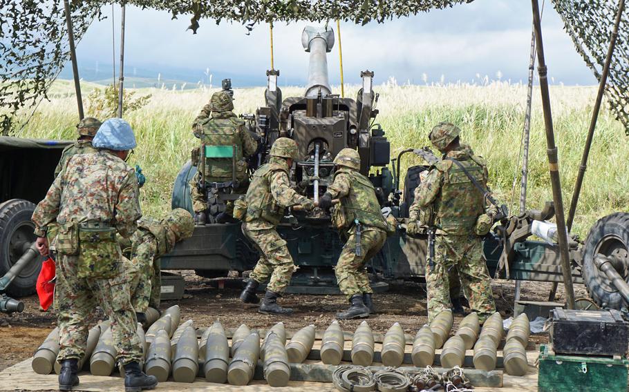 Japanese troops with the 34th Infantry Regiment, 1st Division, Eastern Army load 155mm shells into an FH70 towed howitzer while conducting live-fire artillery training during the Orient Shield exercise at East Fuji Maneuver Area, Japan, Tuesday, Sept. 19, 2017.