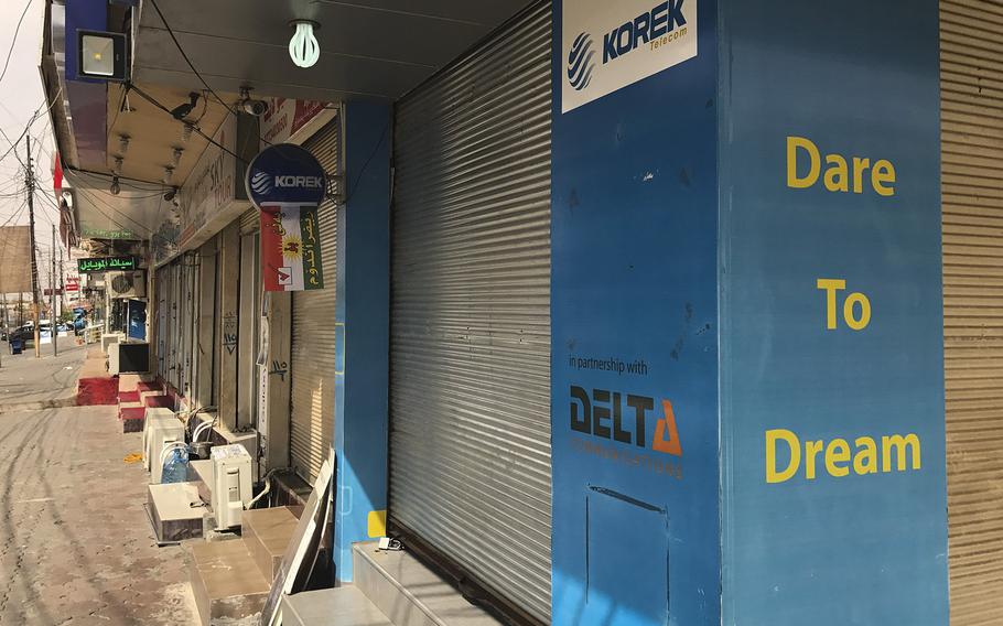 Many shops, like this Korek phone store flying a Kurdish flag promoting the referendum on independence, were closed on Monday, Sept. 25, 2017, to allow Kurds to cast their ballots in the regional government's bid for a mandate to negotiate separation from Iraq.