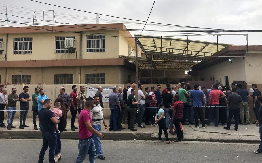 Voters line up to cast their ballots in the Iraqi Kurdistan region's independence referendum on Monday, Sept. 25, 2017, in a suburb of the region's capital of Irbil.