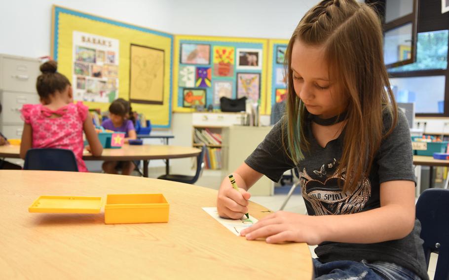 Embree Bench, a second-grader at Ramstein Elementary School in Germany, designs a name tag on the first day of school on Monday, Aug. 28, 2017.Classes for schools in the Kaiserslautern Military Community and Baumholder will start one hour late on Thursdays this month.