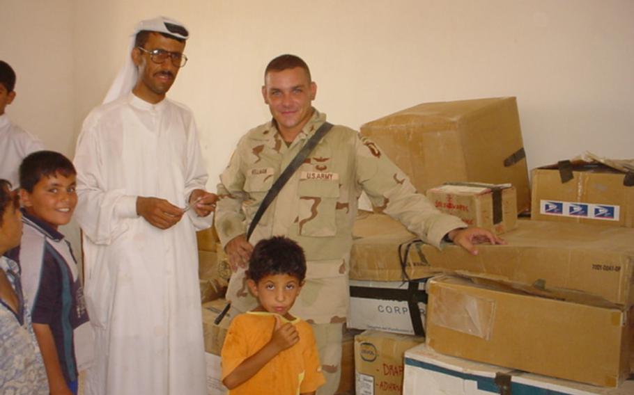 Dr. Mohammed Ismail, left, and then-Maj. Fred Wellman, are pictured here on Sunday, Aug. 10, 2003, in a U.S.-built clinic alongside boxes sent by the American public for ''Operation Fred,'' a campaign to collect school supplies, medicine and other necessary goods after the U.S.-led invasion of Iraq.