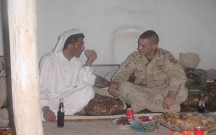 Dr. Mohammed Ismail and then-Maj. Fred Wellman share one of their earliest meals together in Jeddalah, shortly after U.S. troops occupied nearby Qayara Airfield West, in this undated photo from 2003. Mohammed would go on to become an important partner in U.S. reconstruction efforts in the area.