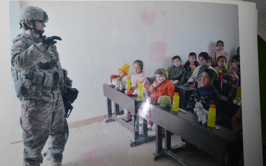 Pictured here is one of many photos the villagers of Jeddalah have collected showing their cooperation with American troops who occupied the nearby Qayara Airfield West from 2003 to 2011. In this undated photo, an unnamed U.S. soldier visits a classroom at a U.S.-build schoolhouse in the village.