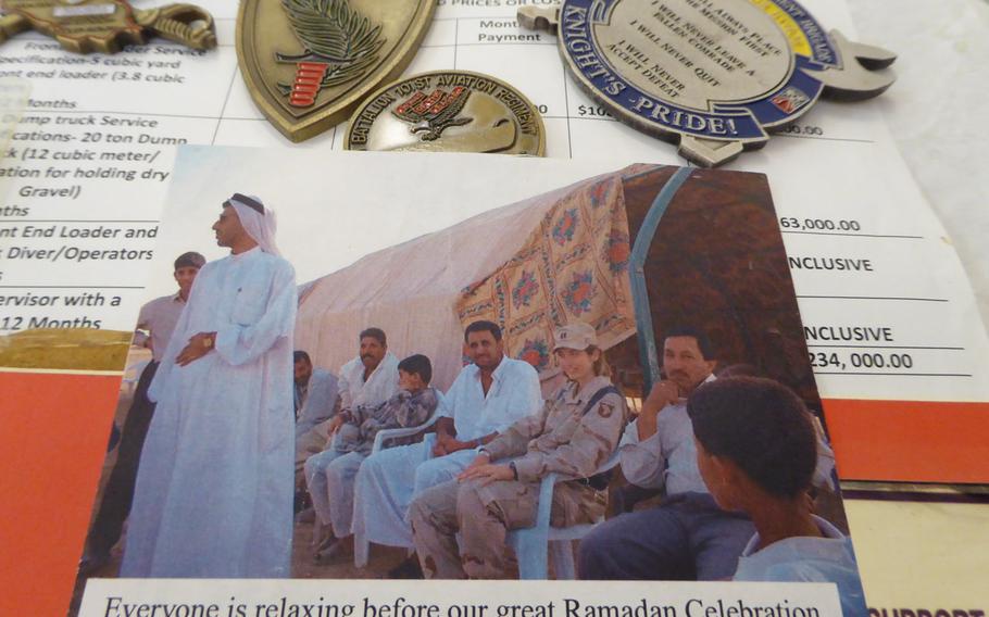 Pictured here are mementos of American and Iraqi cooperation in the village of Jeddalah, including challenge coins, receipts for construction work and a photo of a Ramadan celebration attended by then-Capt. Kellie Rourke. The village, about 40 miles south of Mosul, near Qayara Airfield West, was a hub for U.S. reconstruction efforts.