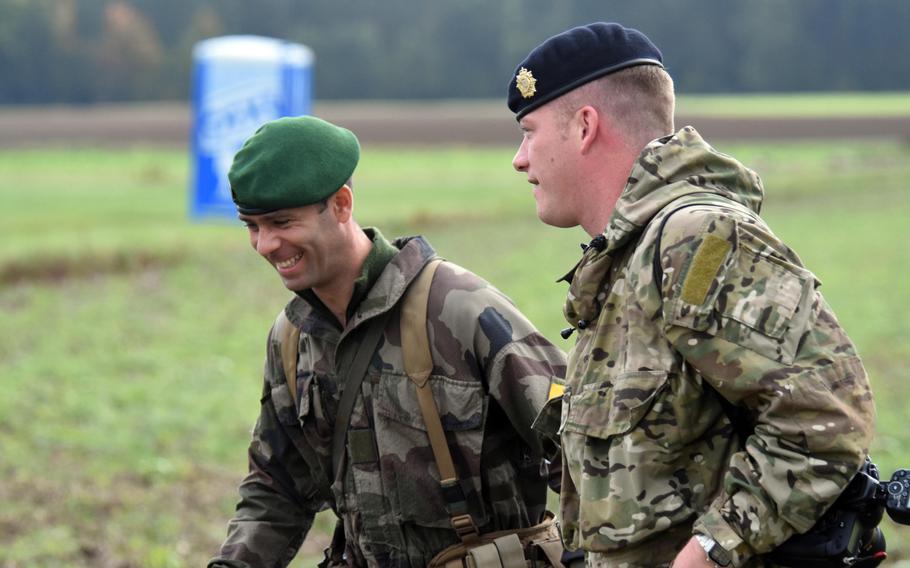 A British paratrooper and French Foreign Legionnaire share a laugh during Exercise Swift Response, at Hohenfels, Germany, Oct. 9, 2017.