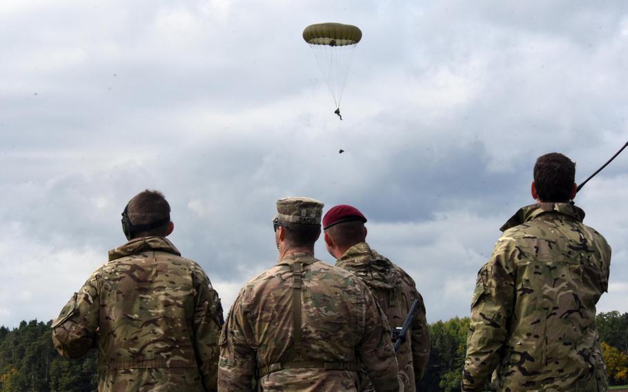 U.S. and British soldiers observe a French Foreign Legionnaire parachute to the ground during Exercise Swift Response, at Hohenfels, Germany, Oct. 9, 2017.