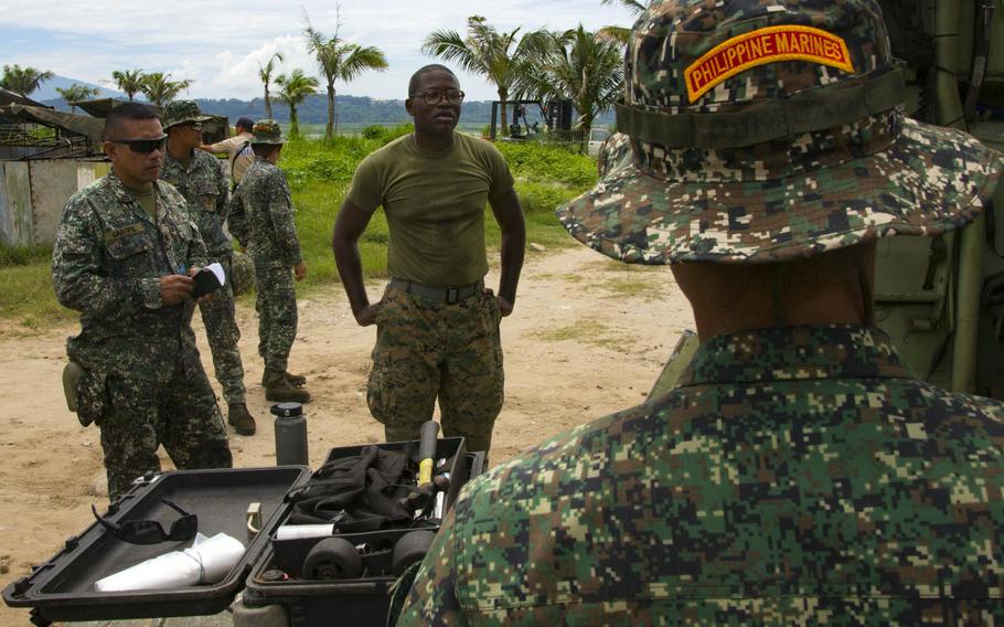 Gunnery Sgt. Troy Telford with Amphibious Assault Company, Combat Assault Battalion, 3rd Marine Division, discusses Assault Amphibious Vehicle procedures before embarking onto the Philippine navy's BRP Tarlac during exercise Kamandag in Subic Bay, Philippines, Oct. 3, 2017.