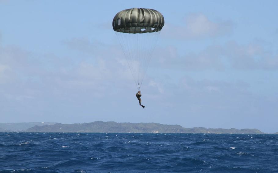 A Marine from 3rd Reconnaissance Battalion, 3rd Marine Division, prepares for splashdown during parachute training off Okinawa's eastern coast, Wednesday, Oct. 11, 2017.