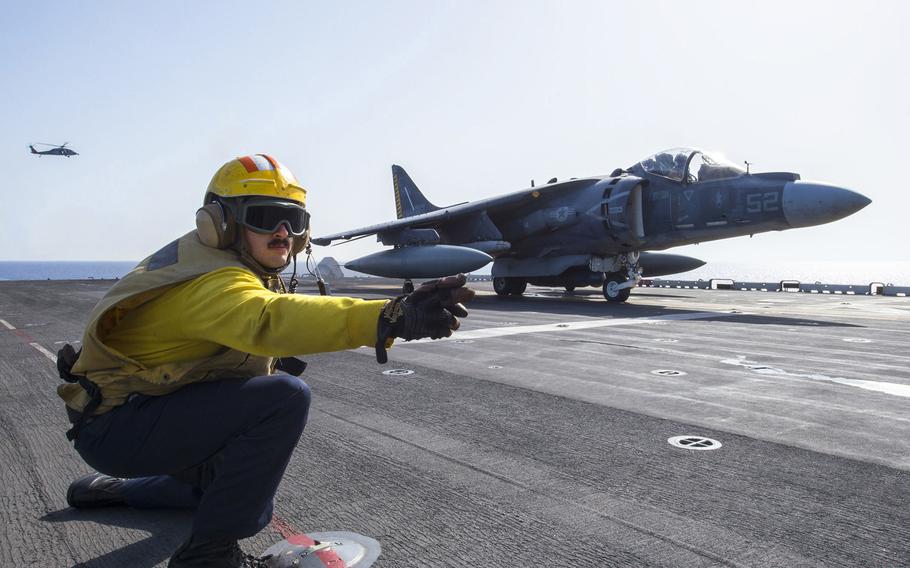 A sailor signals an AV-8B Harrier to take off aboard the amphibious assault ship USS Wasp, Oct. 4, 2016, in support of Libya against the Islamic State. The operation illustrates AFRICOM's growing profile since its inception 10 years ago.
