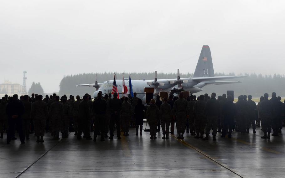 Airmen gather at Yokota Air Base in western Tokyo to bid farwell to the Air Force's last active-duty C-130H Hercules cargo plane, Monday, Oct. 16, 2017.