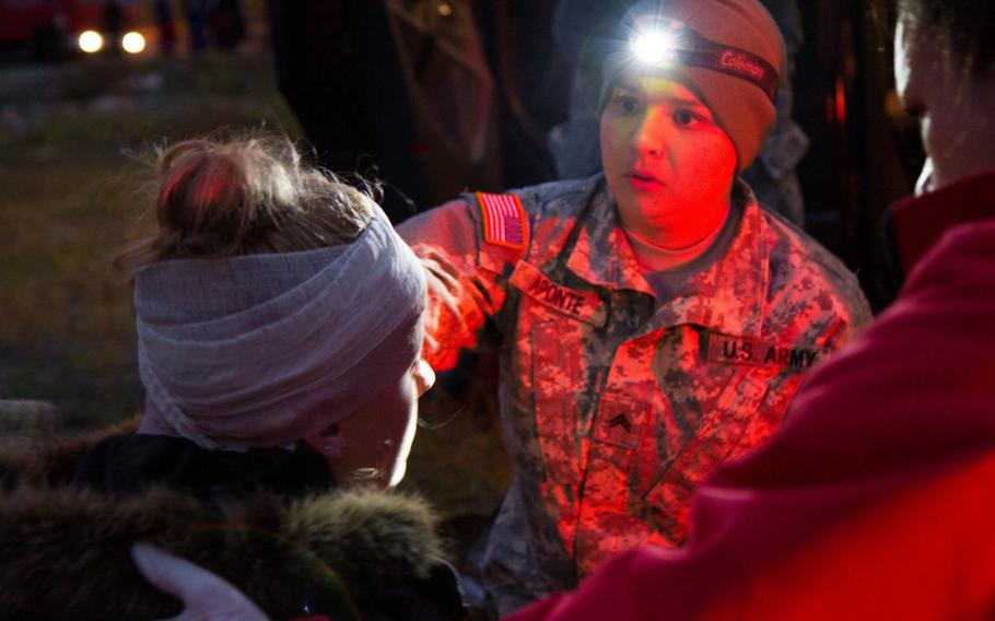 Cpl. Karen Aponte, practical nurse specialist with Medical Support Unit-Europe, 7th Mission Support Command, helps treat a role-playing casualty with assistance from a local paramedic during an exercise in Bosnia and Herzegovina, Sept. 27, 2017. The Army is considering increasing reimbursements for reservists traveling to drills and long-term training.