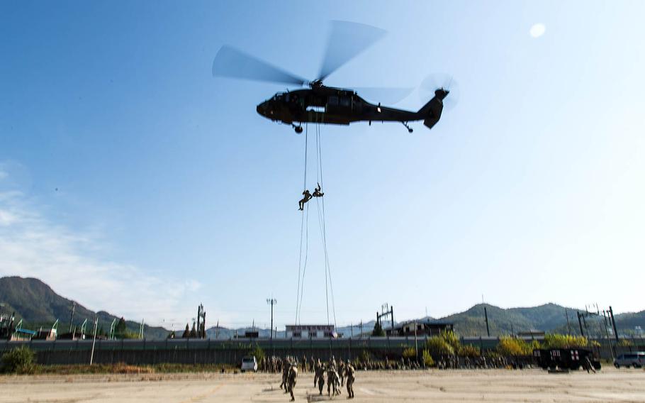 Two students rappel out of a helicopter at Camp Mobile, South Korea, Thursday, Oct. 19, 2017.