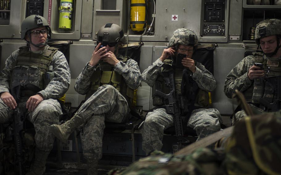 Airmen check their cellphones during a flight aboard a C-17 Globemaster III on Jan. 13, 2014. NATO's long-standing advantage in air, at sea and on land could be put at risk as highly skilled cyber adversaries probe for weaknesses.