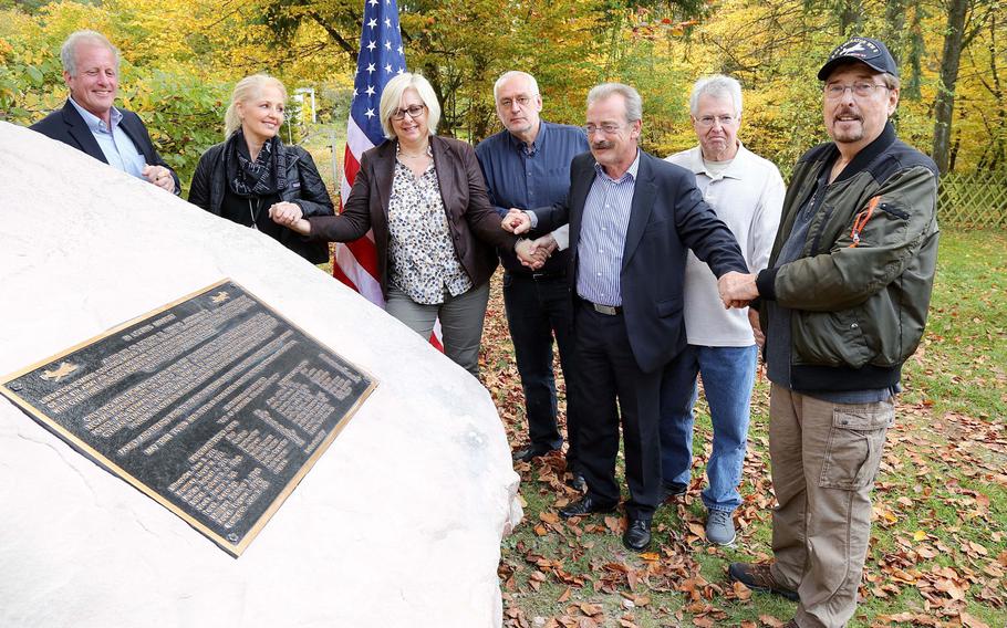 From left: Tom Burton; Mary Burton; Edenkoben Vice Mayor Angelika Fesenmeyer; Uwe Benkel, leader of Searching for the Missing; Edenkoben Mayor Olaf Gouase; John Torok; and Dennis Lithander come together Oct. 19, 2017, for the unveiling of a memorial for 14 servicemembers who died Oct. 19, 1944, during a B-24 bombing raid in Germany.