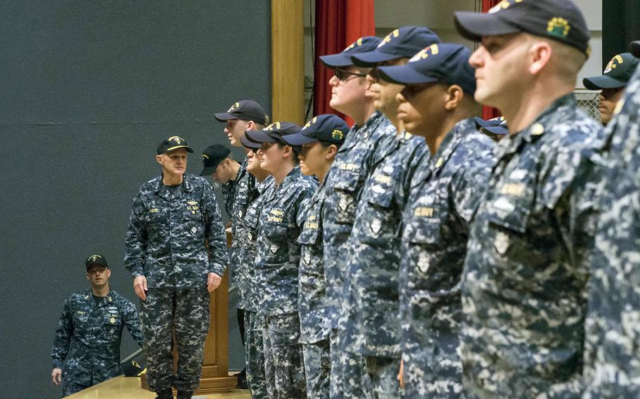 Seventh Fleet Commander Vice Adm. Phil Sawyer awards the Navy and Marine Corps Commendation Medal to 36 crew members of the USS Fitzgerald, Friday, Oct. 20, 2017.