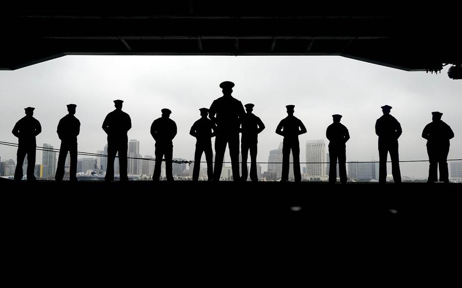 Sailors man the rails aboard the aircraft carrier USS Nimitz in San Diego, June 5, 2017.