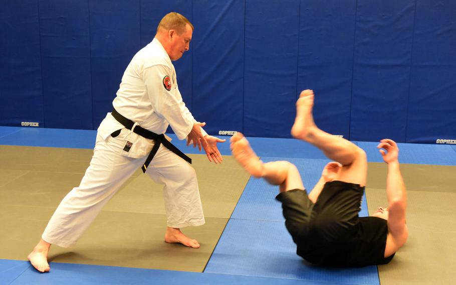 Base chaplain Maj. Kevin Hovan, left, throws Pfc. Nikolas Petrosyan to the ground during an aikido class at Grafenwoehr, Germany, Tuesday, Oct. 24, 2017.