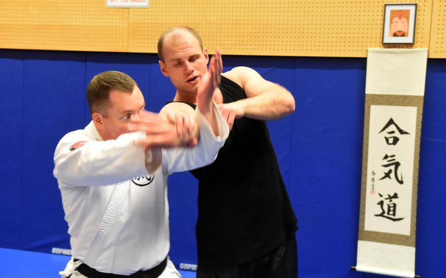 Base chaplain Maj. Kevin Hovan, left, demonstrates an aikido move on Pfc. Nikolas Petrosyan during an aikido class at Grafenwoehr, Germany, Tuesday, Oct. 24, 2017.