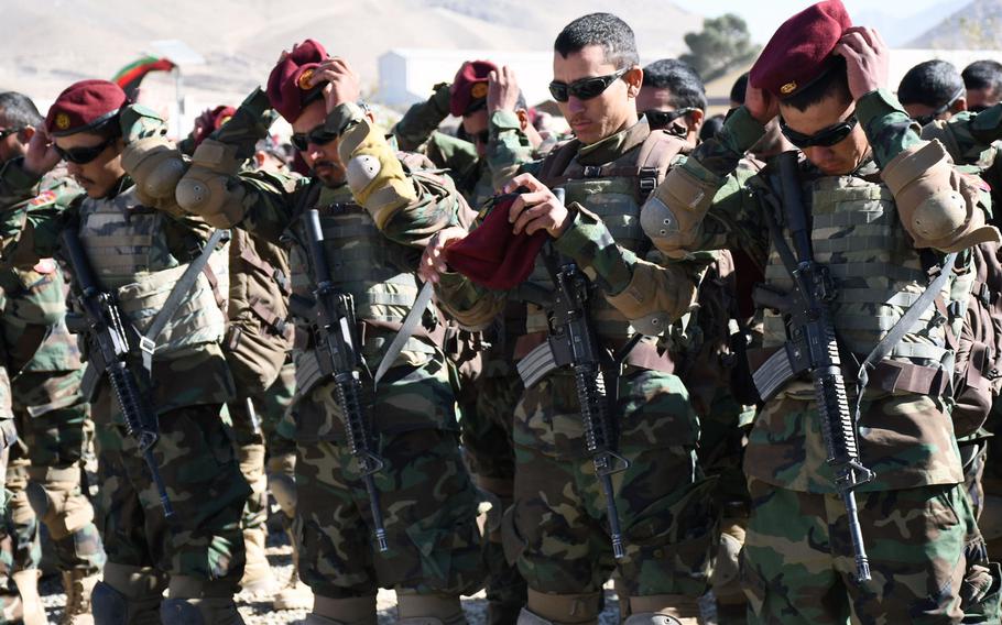 New Afghan commandos put on the signature maroon beret for the first time at a graduation ceremony in Kabul on Wednesday, Oct. 25, 2017.