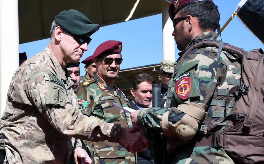 Army Maj. Gen. James B. Linder, commanding general of Special Operations Joint Task Force-Afghanistan, left, congratulates a newly graduated Afghan commando at a ceremony in Kabul on Wednesday, Oct. 25, 2017.