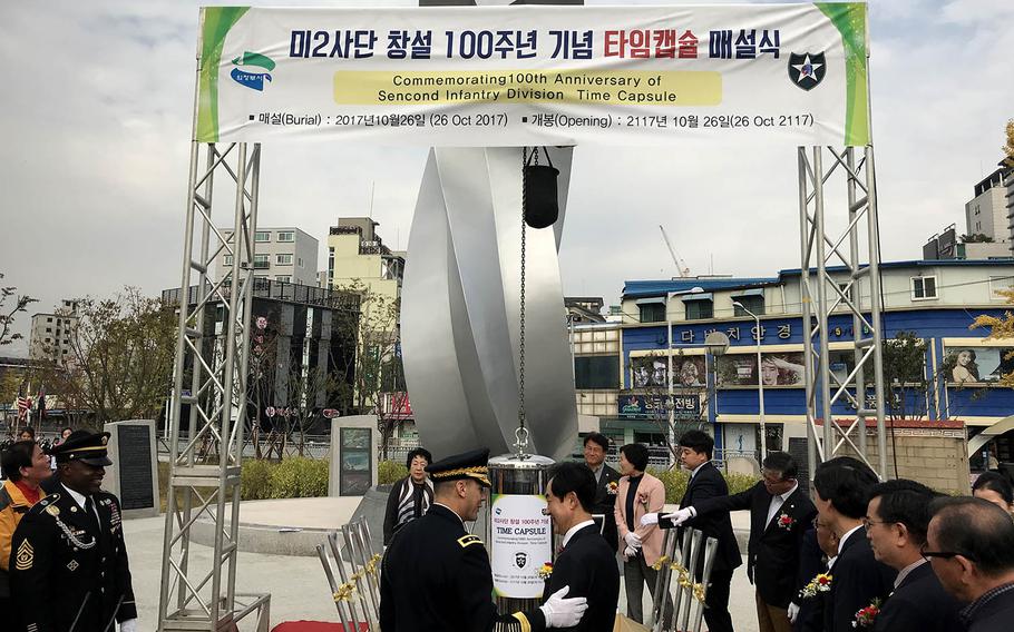 Officials from Uijeongbu, South Korea, and the 2nd Infantry Division bury a time capsule at Camp Casey, South Korea, Thursday, Oct. 26, 2017.