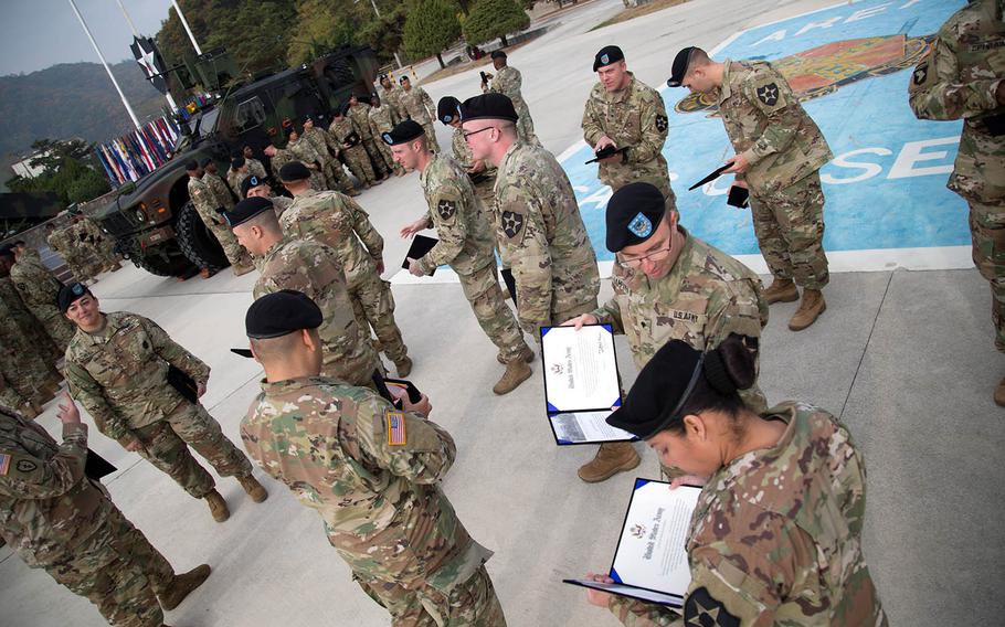 Recently re-enlisted soldiers review their certificates at Camp Casey, South Korea, Thursday, Oct. 26, 2017.