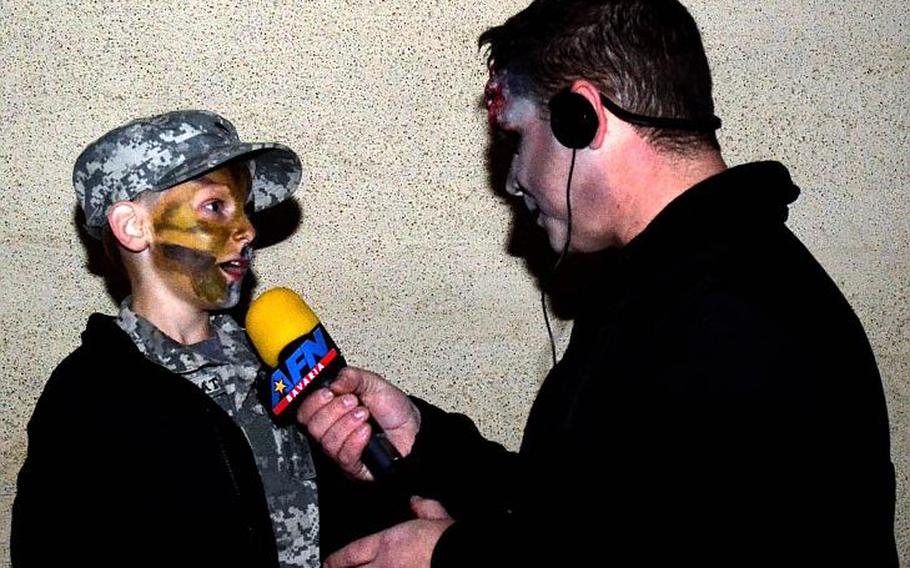 Bently Raven, 6, talks with American Forces Network Radio Europe in the Haunted Village at the Hohenfels Training Area, Germany, Oct. 28, 2017. The 1st Battalion, 4th Infantry Regiment ran the village.