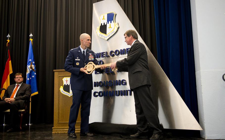 Col. Jason Bailey, 52nd Fighter Wing commander, left, gives a symbolic key to Alois Boerder, an Institute for Federal Real Estate representative, during a ceremony to turn over the Bitburg Annex housing area to the German government, Monday, Nov. 6, 2017.