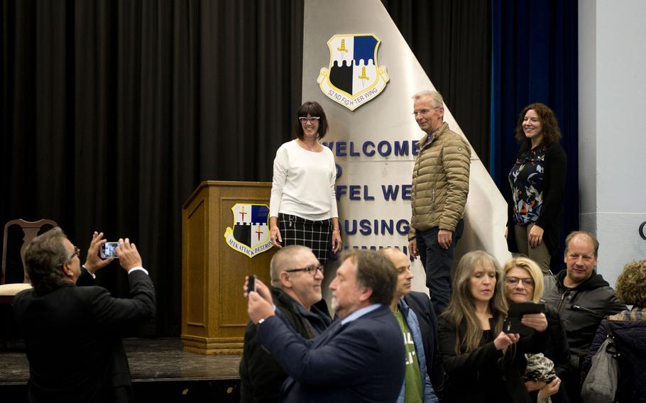 Attendees take photos in front of the Bitburg housing area sign after a ceremony to turn over the former air base annex to the German government in Bitburg, Germany, on Monday, Nov. 6, 2017.