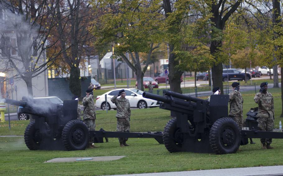 Members of the 529th Military Police Company Salute Battery salute during retreat after firing their cannons at a Veterans Day observance at Clay Kaserne in Wiesbaden, Germany. The battery fired a blank round during the playing of "Taps" and the lowering of the U.S. and German flags.