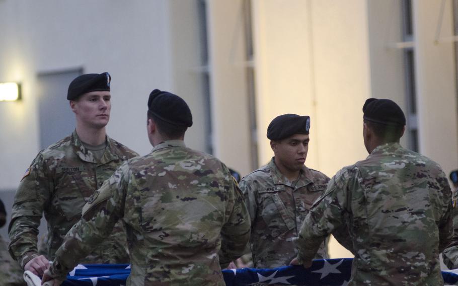 Soldiers from U.S. Army Europe fold the U.S. flag during a Veterans Day retreat ceremony at Clay Kaserne in Wiesbaden, Germany. This year's ceremony marked 100 years since U.S. troops first arrived to support the Allies in World War I.