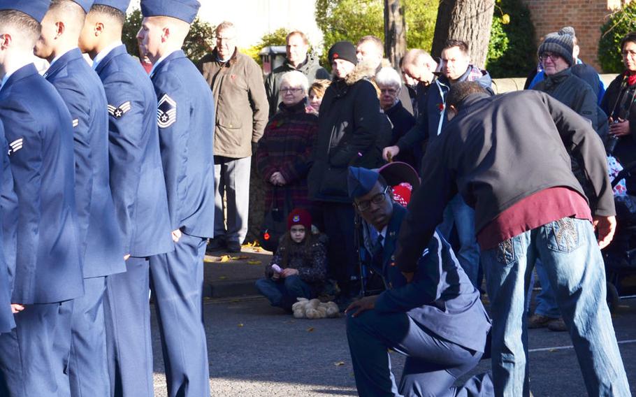 An airman, while part of a ceremonial detail from RAF Mildenhall, stepped out of the formation and took a knee when the music to reveille began playing during a Remembrance Day ceremony in Mildenhall, England, on Sunday, Nov. 12, 2017. Air Force officials said the airman felt faint, but others on social media interpreted the photo as a protest. The airman previously stood and saluted during the U.S. and British national anthems.