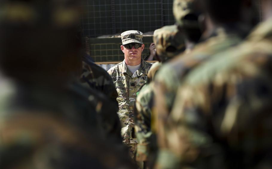 Army Capt. Seth Church with the 101st Airborne Division stands in front of a formation of Somali National Army soldiers during a graduation ceremony in Mogadishu, Somalia, May 24, 2017.