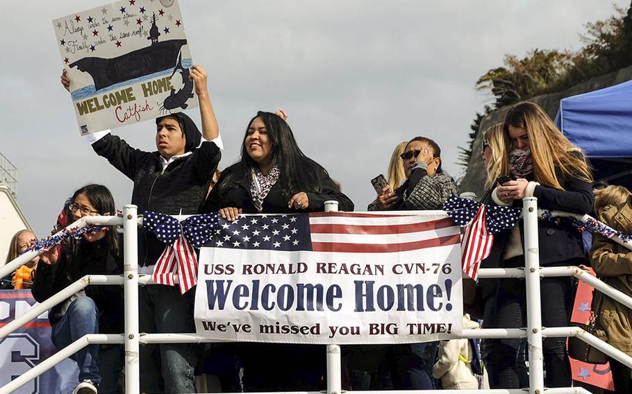 Families welcome the USS Ronald Reagan home to Yokosuka Naval Base, Japan, Monday, Dec. 4, 2017.