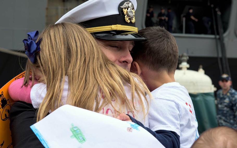 Lt. j.g. Christopher Moulton of Grass Lake, Mich., reunites with his family after the USS Ronald Reagan arrives home at Yokosuka Naval Base, Japan, Monday, Dec. 4, 2017.