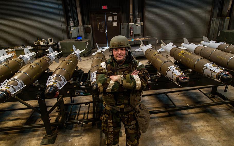 Staff Sgt. Justin Hibbard of the 51st Munitions Squadron poses in front of his handiwork at Osan Air Base, South Korea, Wednesday, Dec. 6, 2017.