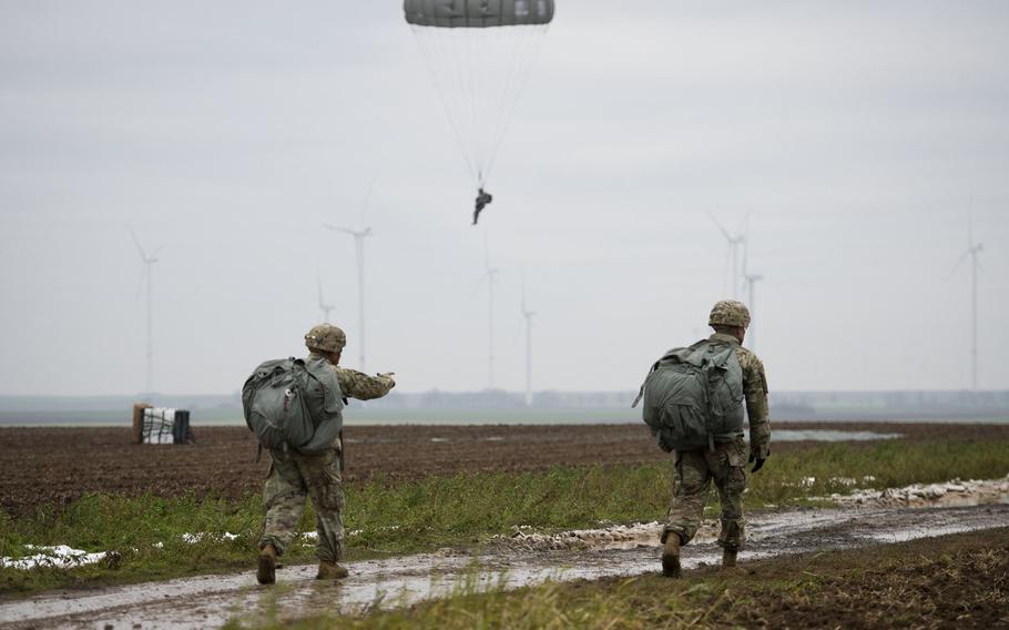 U.S. paratroopers walk to a rally point after landing in a field near Alzey, Germany, on Wednesday, Dec. 6, 2017.