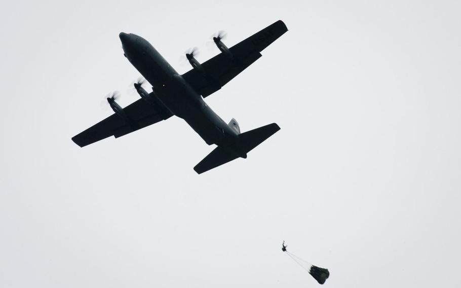 Paratroopers jump from a U.S. Air Force C-130 over a landing zone near Alzey, Germany, on Wednesday, Dec. 6, 2017.