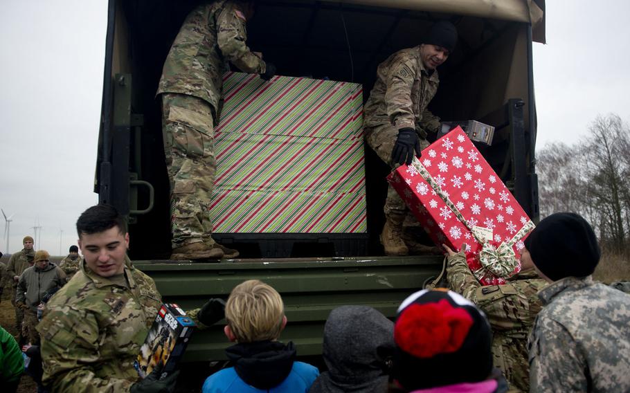 Soldiers from the 16th Sustainment Brigade hand out toys to children near Alzey, Germany, on Wednesday, Dec. 6, 2017.