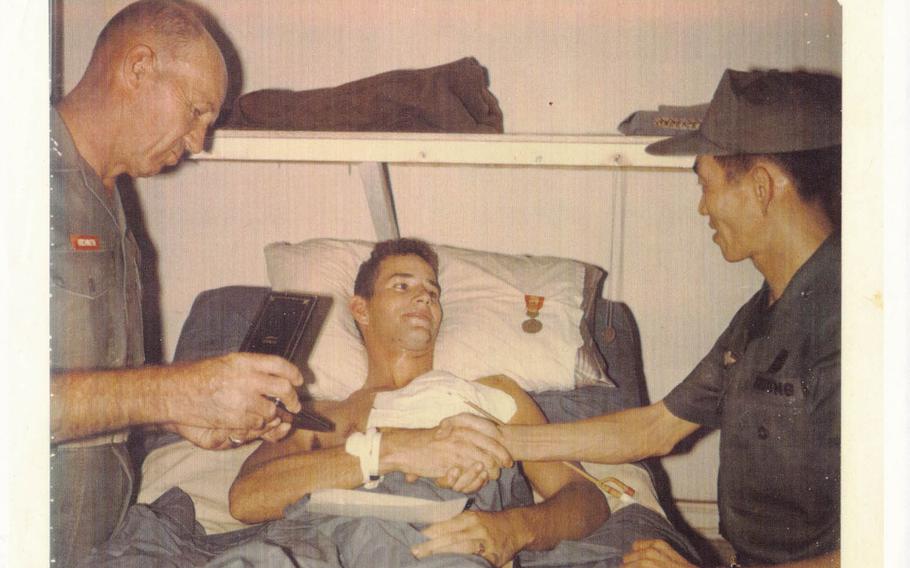 John Musgrave receives a Purple Heart while lying in a hospital bed in the surgical intensive care ward of Alpha Medical Battalion at a Marine base in Phu Bai, Vietnam on Nov. 10, 1967, after he was shot in the face by a North Vietnamese sniper. The 19-year-old infantry rifleman sustained life-threatening and permanently disabling injuries and overcame severe post-traumatic stress and now helps to counsel post-911 veterans. 
Photo courtesy of John Musgrave