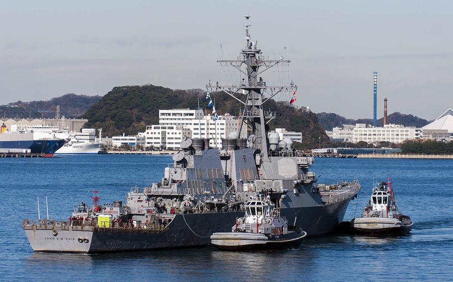 The guided-missile destroyer USS John S. McCain is towed to the pier at Yokosuka Naval Base, Japan, Wednesday, Dec. 13, 2017.