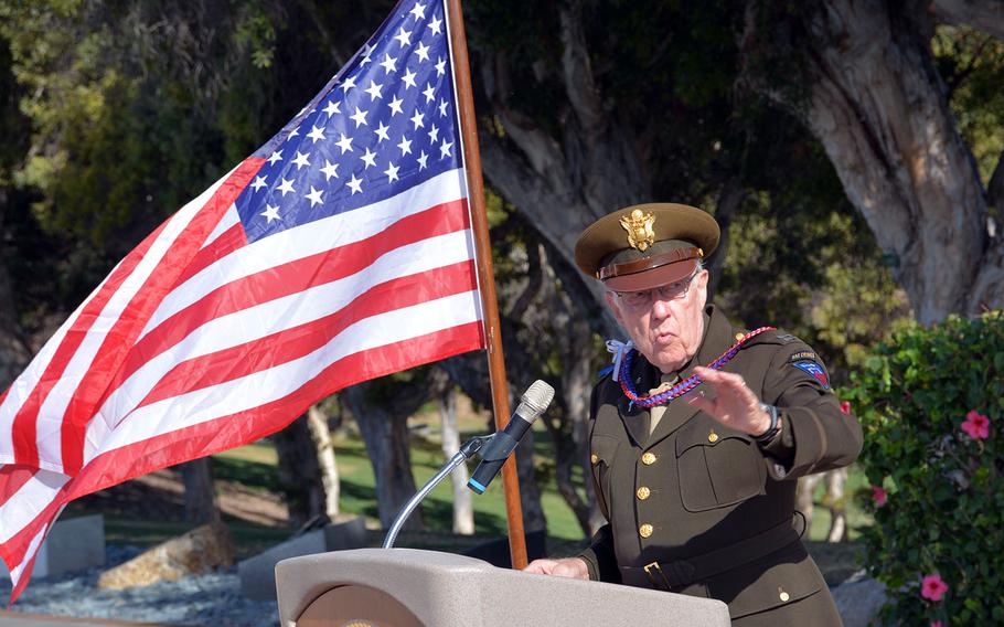 Retired Army chaplain Richard Stenbakken, clad in the type of uniform worn by chaplains during World War II, speaks at a ceremony dedicating a monument to chaplains at the Punchbowl cemetery in Honolulu, Wednesday, Dec. 13, 2017.