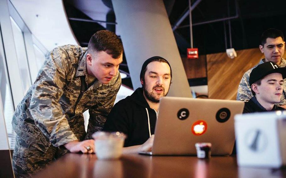 First Lt. Stephen Baker of the 352nd Cyber Operations Squadron watches as a civilian hacker attempts to breach the security of a military website during Hack the Air Force 2.0 in New York City, Dec. 9, 2017.