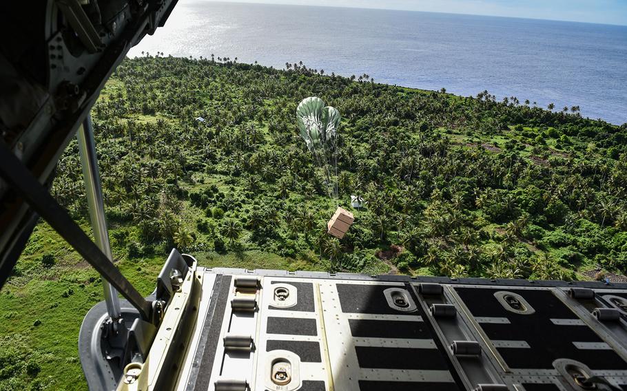 A bundle filled with donated goods parachutes to the island of Fais from a C-130J Super Hercules during Operation Christmas Drop, Dec. 11, 2017.
