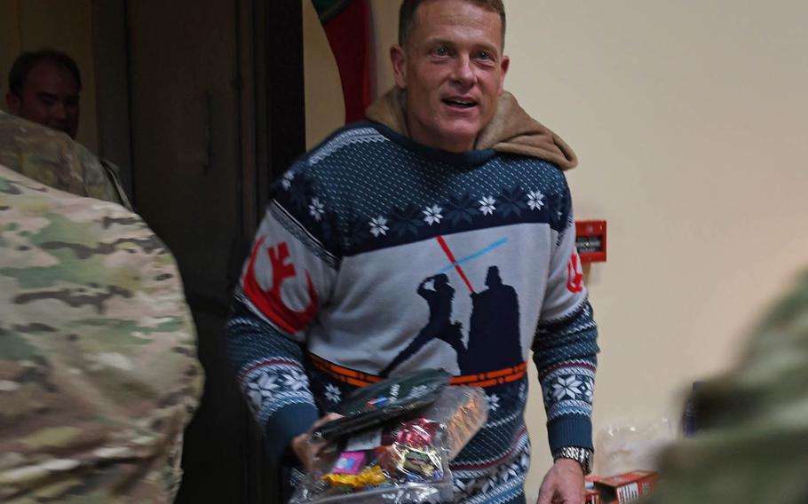 Chaplain Chris Conklink, wearing a Rudolph the Red Nosed Reindeer onesie and a Star Wars Christmas sweater, hands out care packages as troops leave a special AAFES-sponsored screening of "Star Wars: The Last Jedi" at the chapel on a coalition base at Kabul's international airport on Saturday, Dec. 23, 2017.