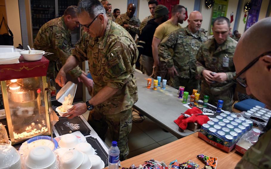 Chief Master Sgt. Orin Johnson serves up popcorn for the troops at a screening of "Star Wars: The Last Jedi" at a coalition base's chapel at Hamid Karzai International Airport in Kabul, Afghanistan, on Saturday, Dec. 23, 2017.