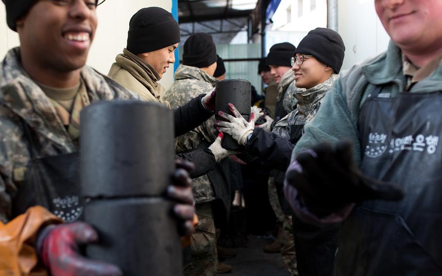 Soldiers from 1st Battalion, 38th Field Artillery Regiment donate charcoal briquettes to homes in Yeoncheon, South Korea, Thursday, Dec. 28, 2017.