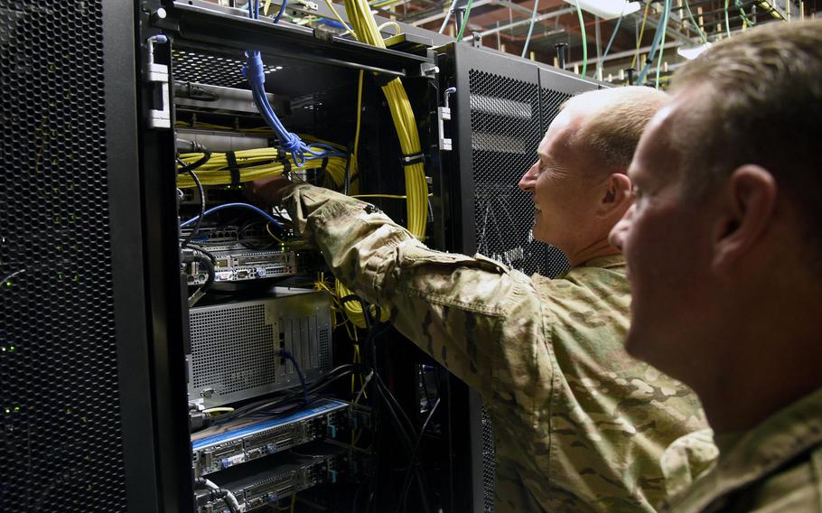 Col. William Burks, 455th Air Expeditionary Wing vice commander, plugs the new Comprehensive Airman Fitness network Ethernet cable into a server rack Oct. 31, 3017, at Bagram Airfield, Afghanistan. The bandwidth was increased by 800 percent and network coverage area was expanded.
