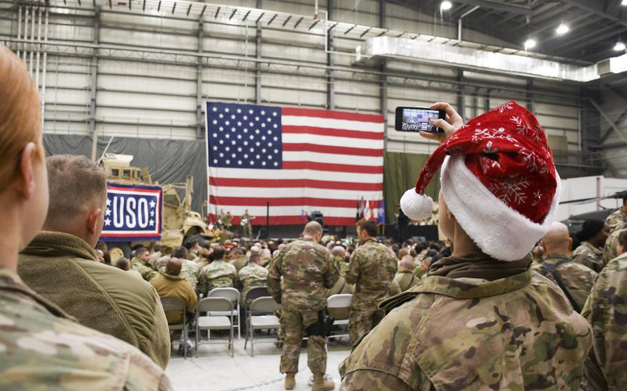 Tech. Sgt. Tarah White takes a video on her smartphone during a Christmas Eve USO show at Bagram Air Force Base on Sunday, Dec. 24, 2017.